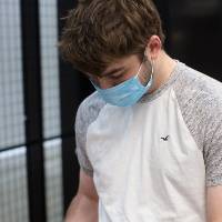 Student looks at robot